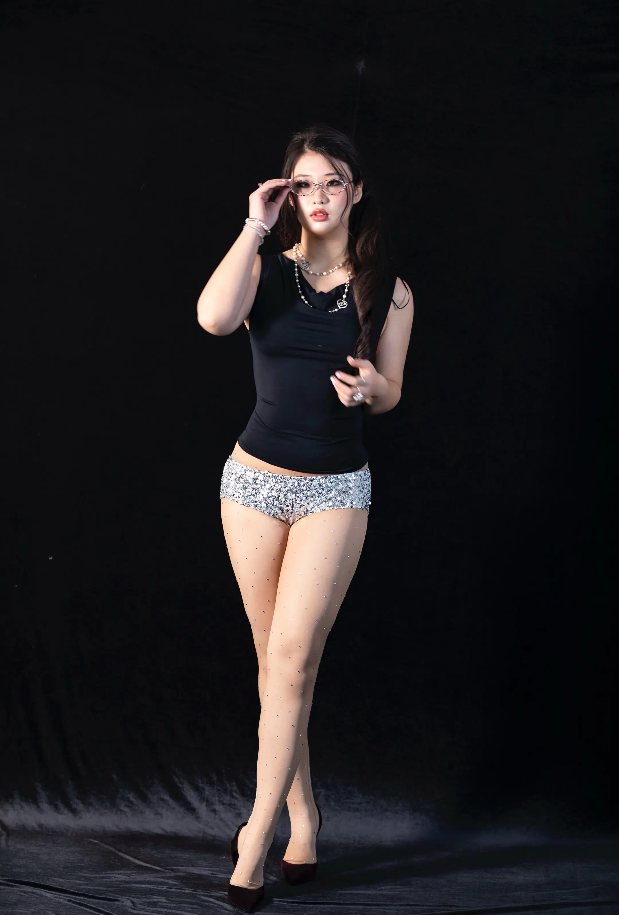 woman with glasses wearing shiny shorts