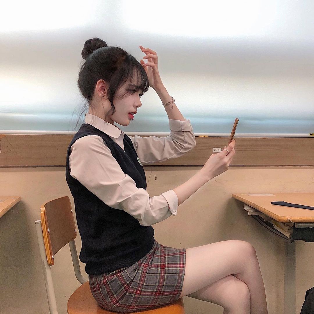 female student taking selfie in classroom