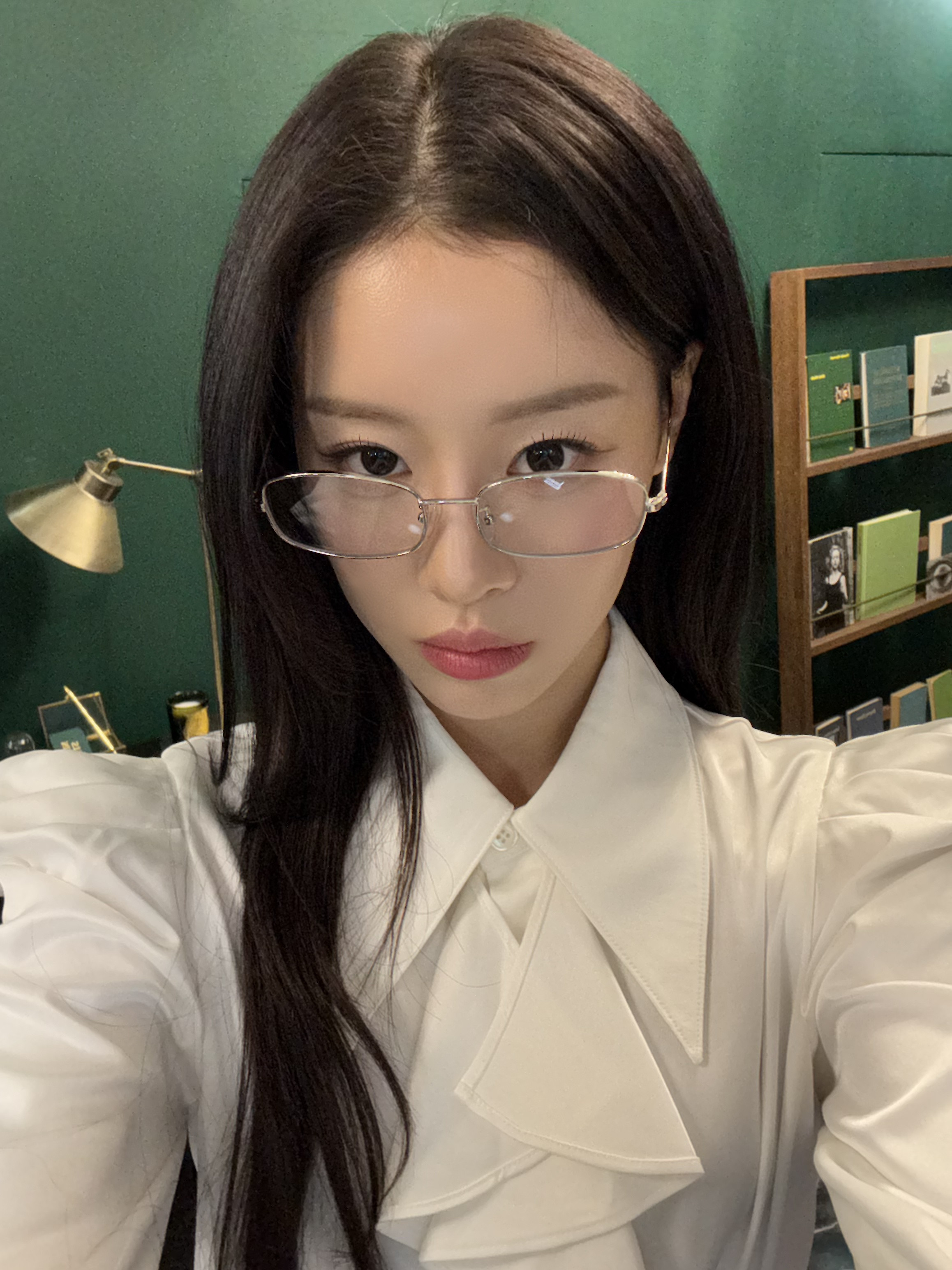 woman wearing glasses taking selfie